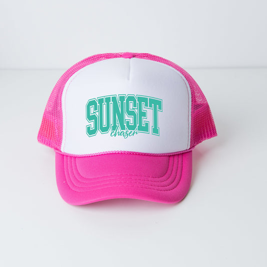 a pink and white hat with the word sunset on it